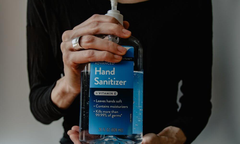hands using hand sanitizer