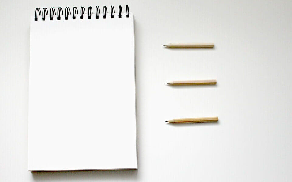 an image of a notepad and pencils
