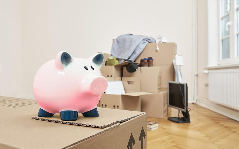 A piggy bank and small cardboard boxes