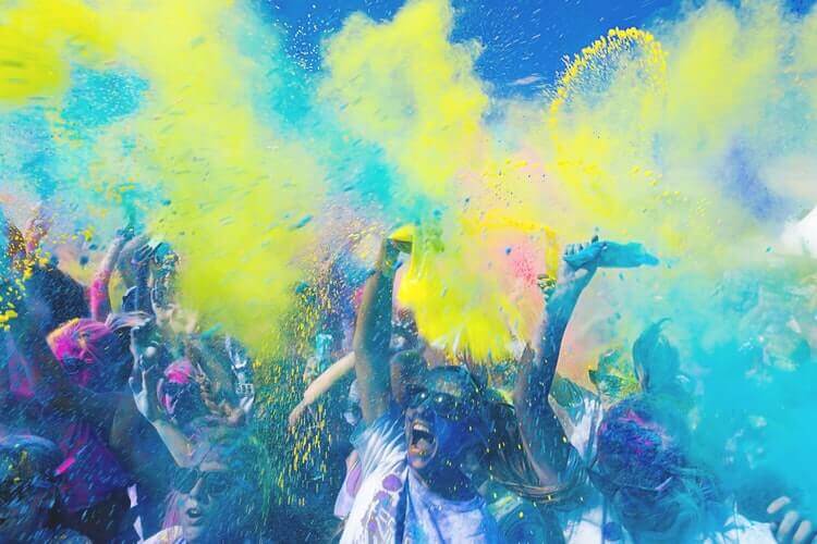 People holding bags with colored powder