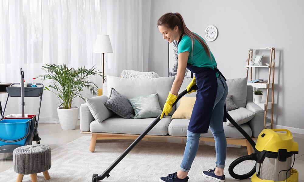 A woman hoovering the floor