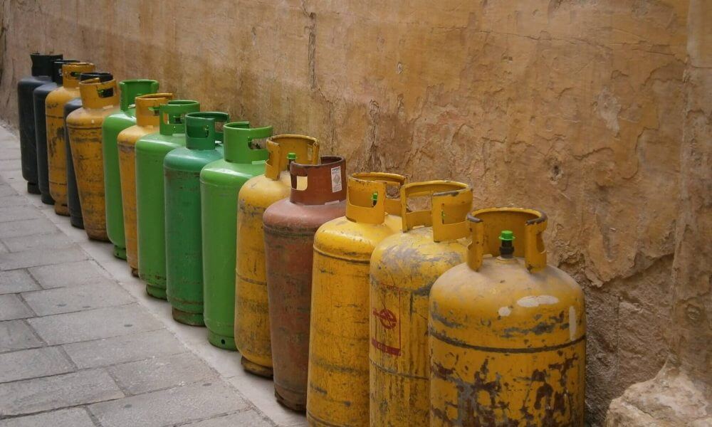 A row of gas bottles by the wall