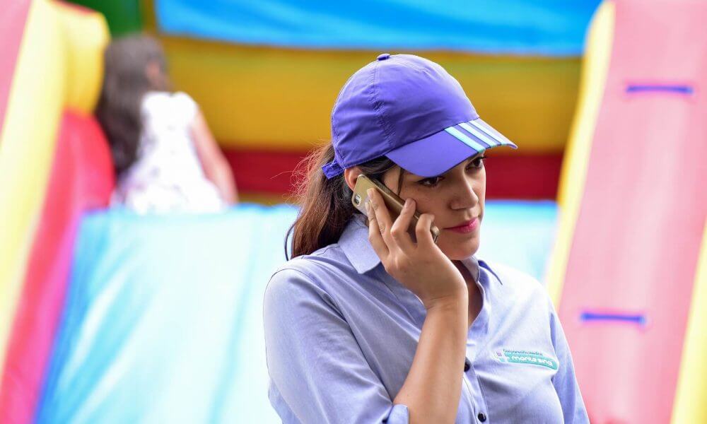 A woman with a cap talking on the phone