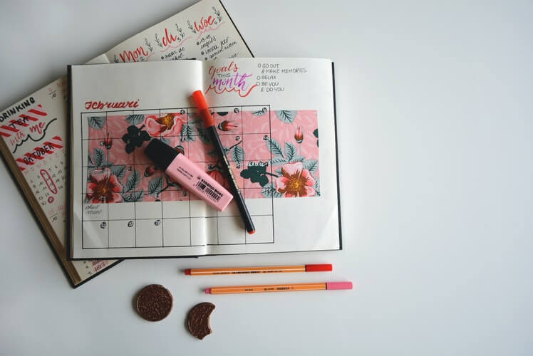 Pink highlighter on a planner