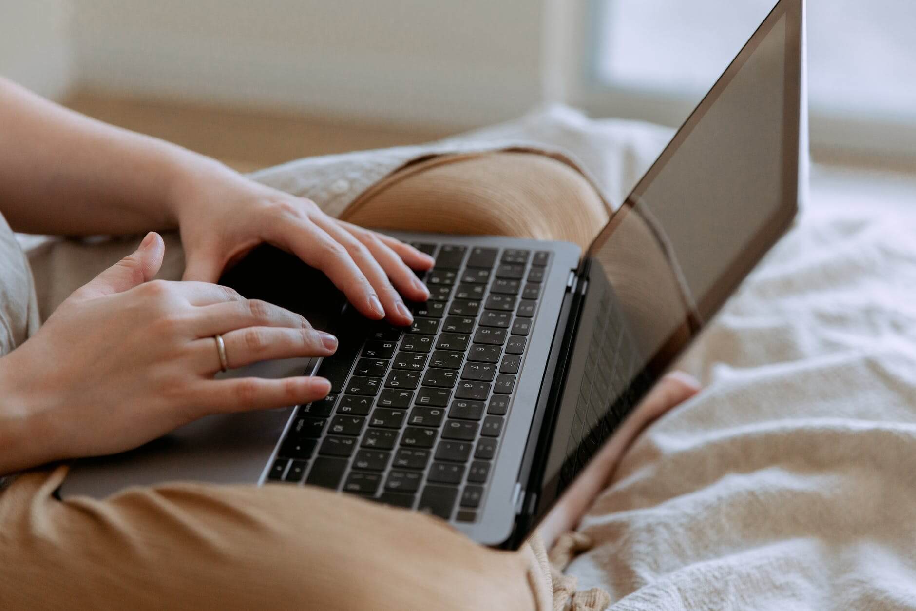 A woman with a laptop in the bed