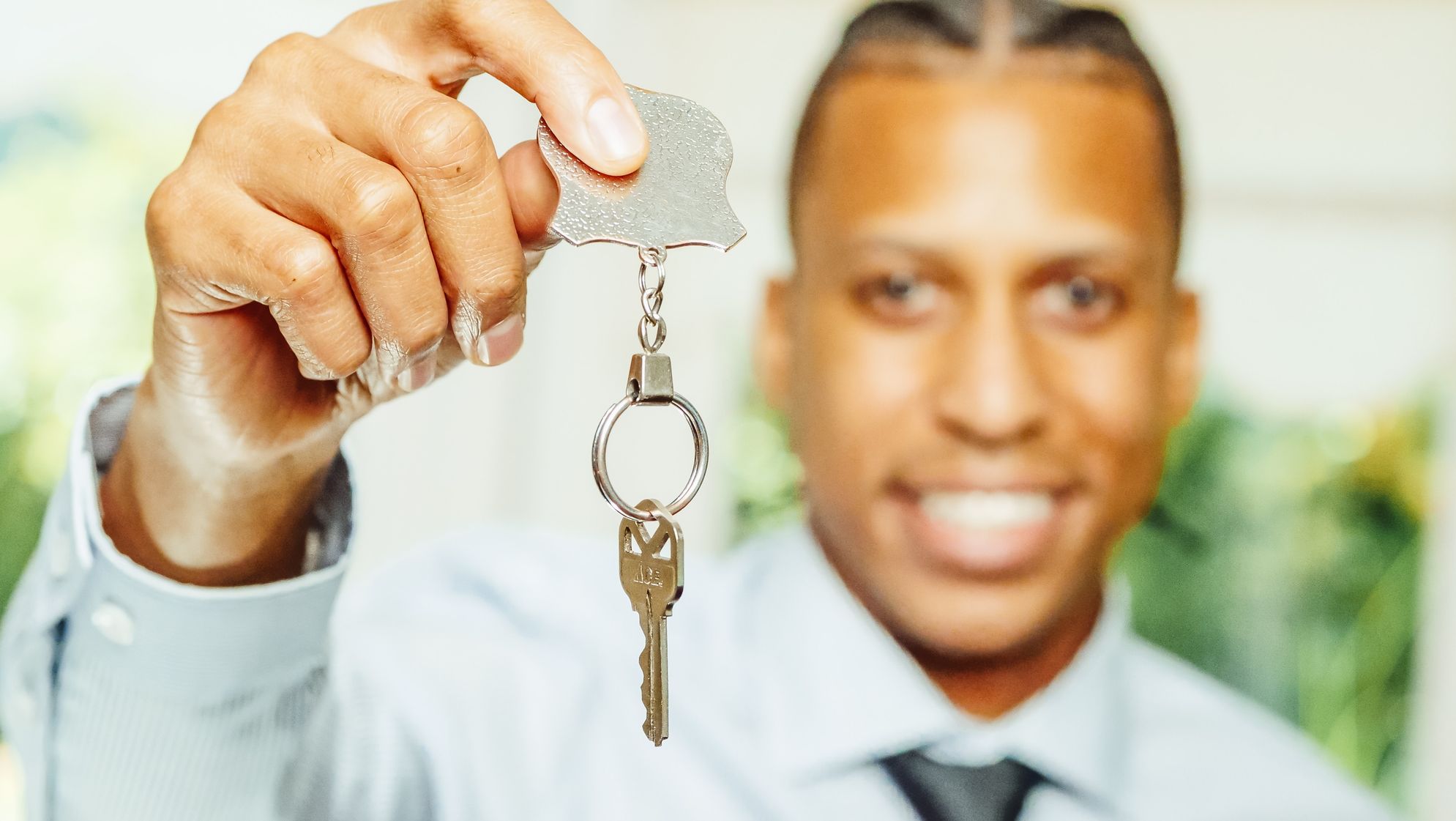 man is holding keys of a new home