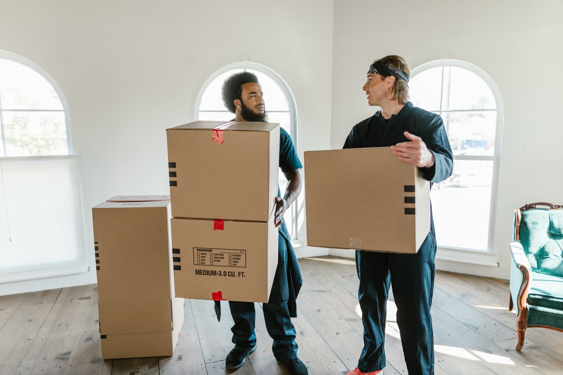 Two long-distance movers holding boxes