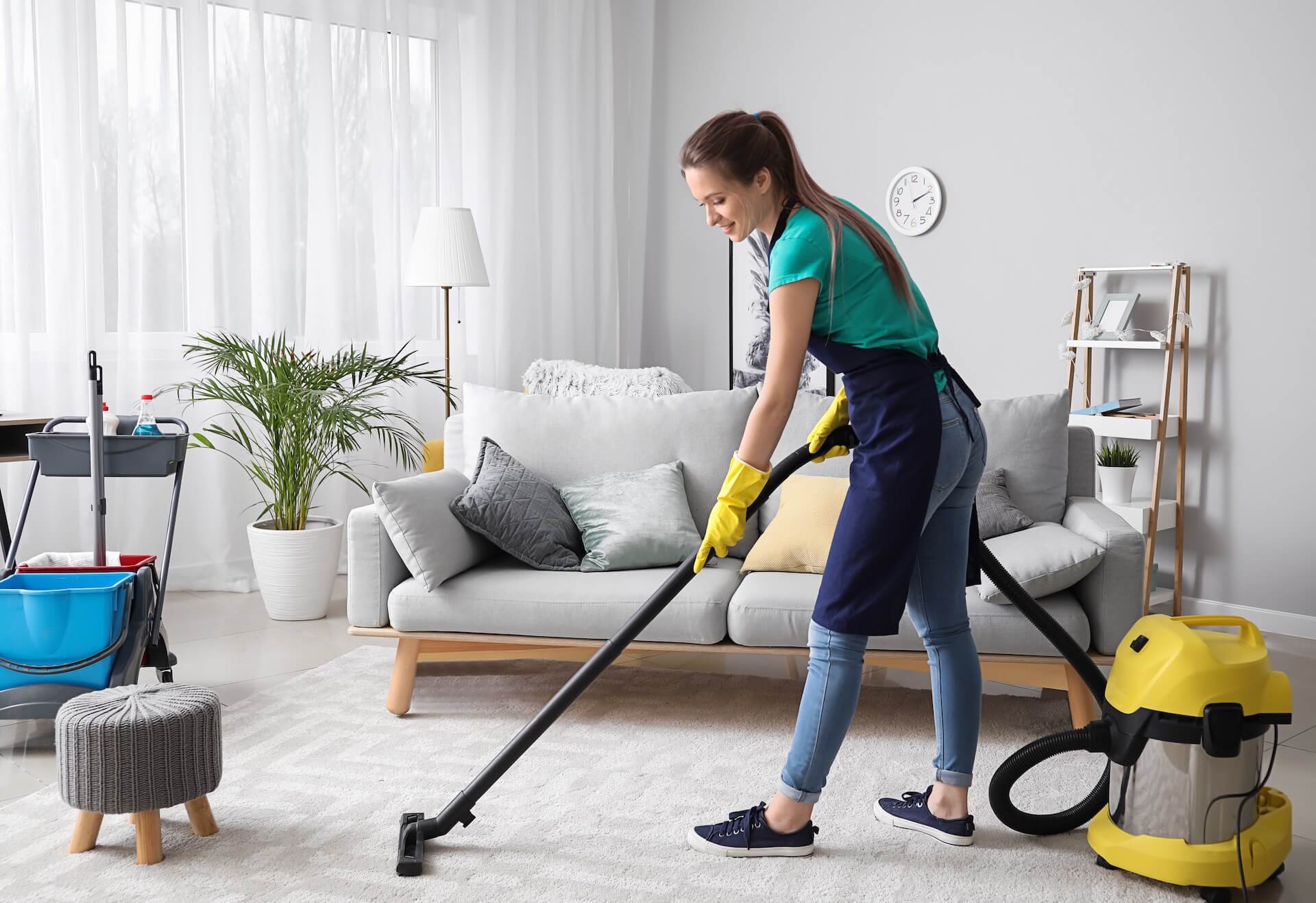 Girl vacuuming to prove that she's ready for cross-country moving