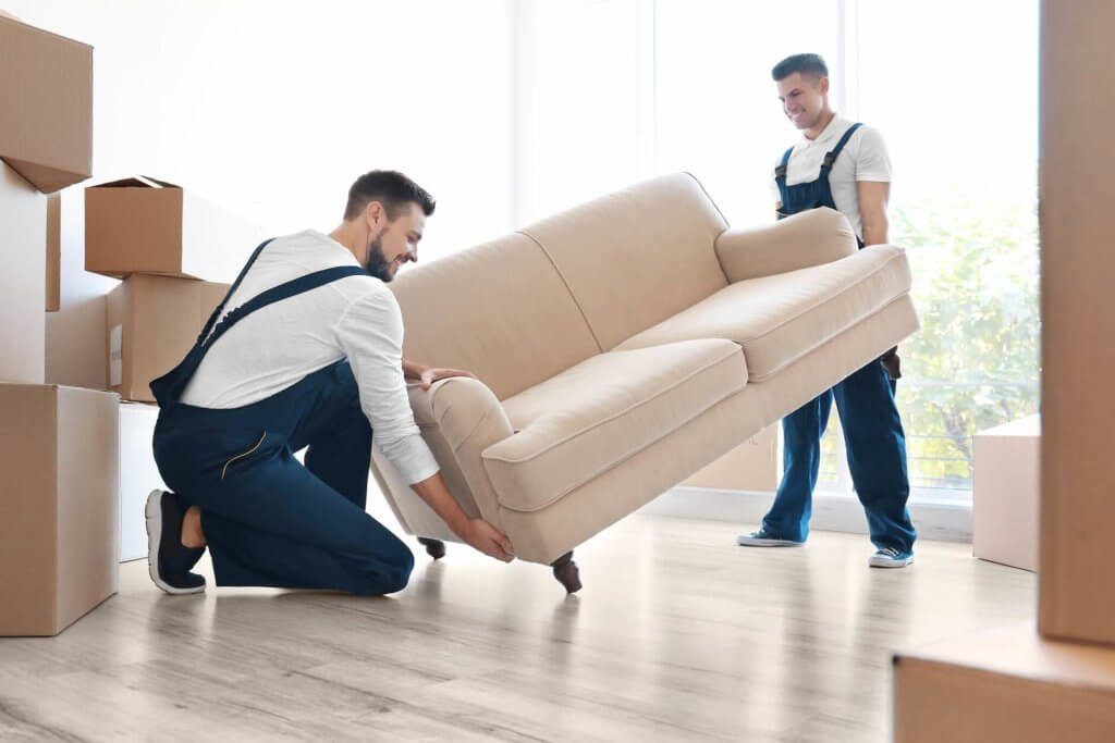 Professional long-distance movers preparing furniture for cross-country moving