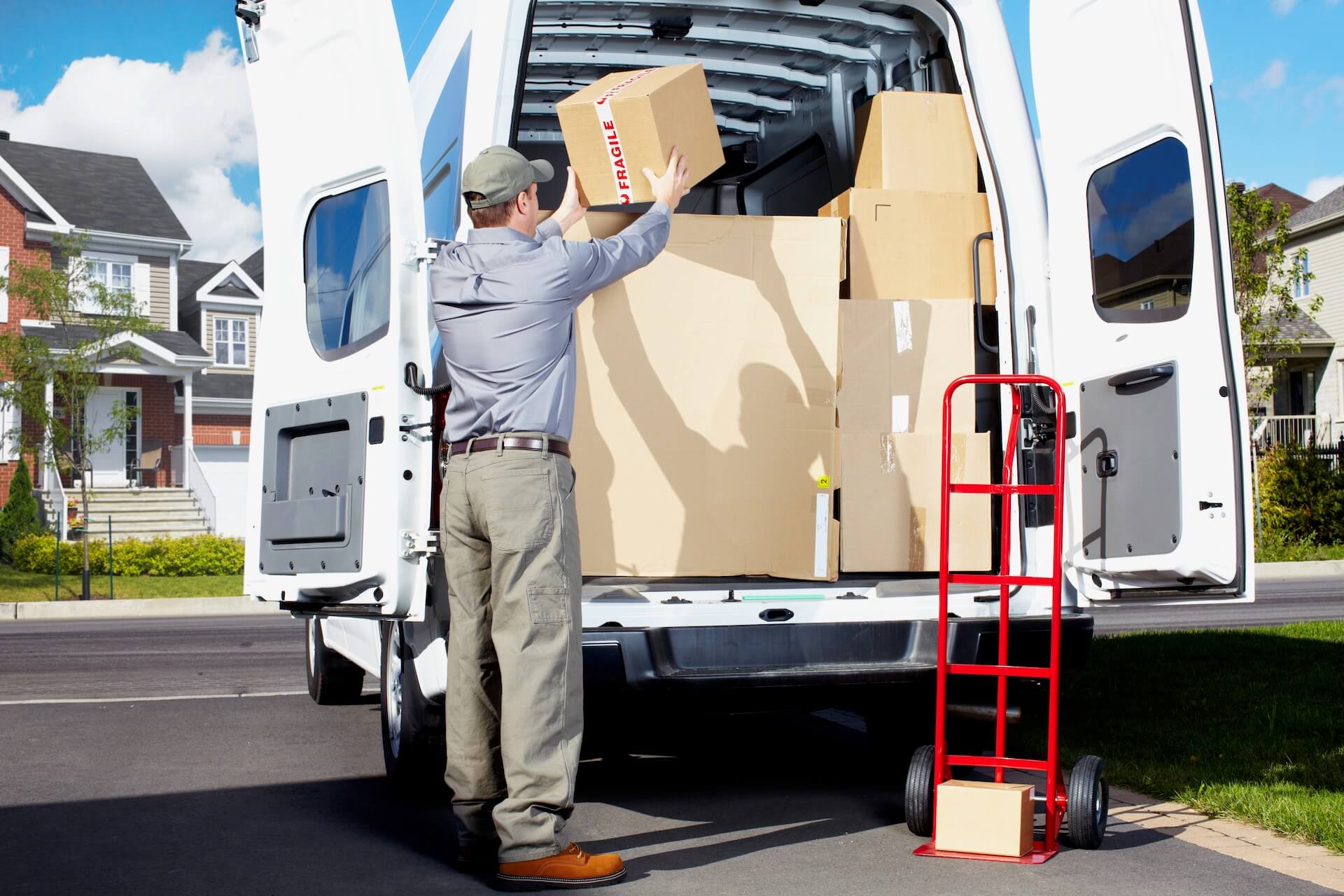 A man placing a box into a van