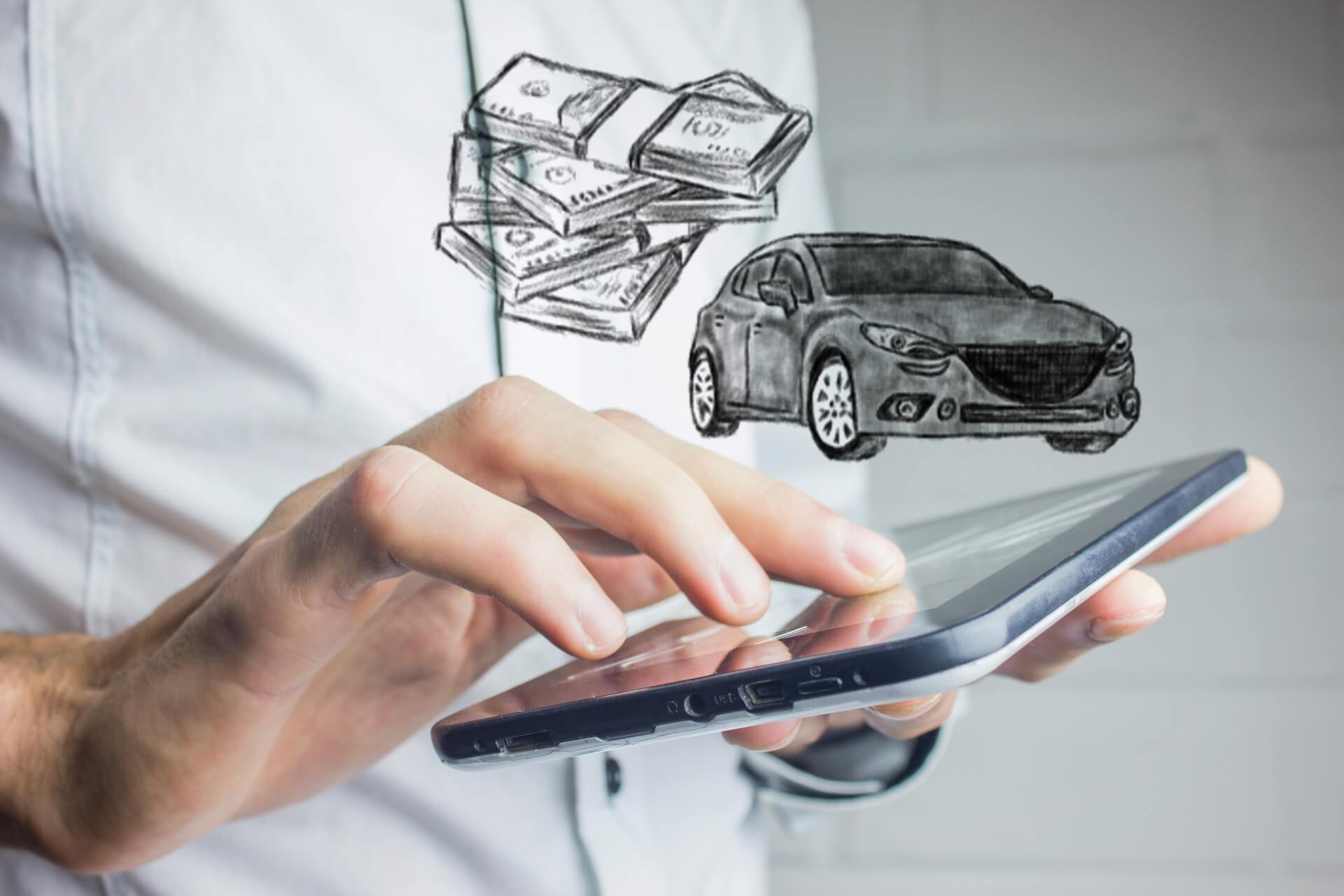 A man with a tablet, with a picture of a car and money