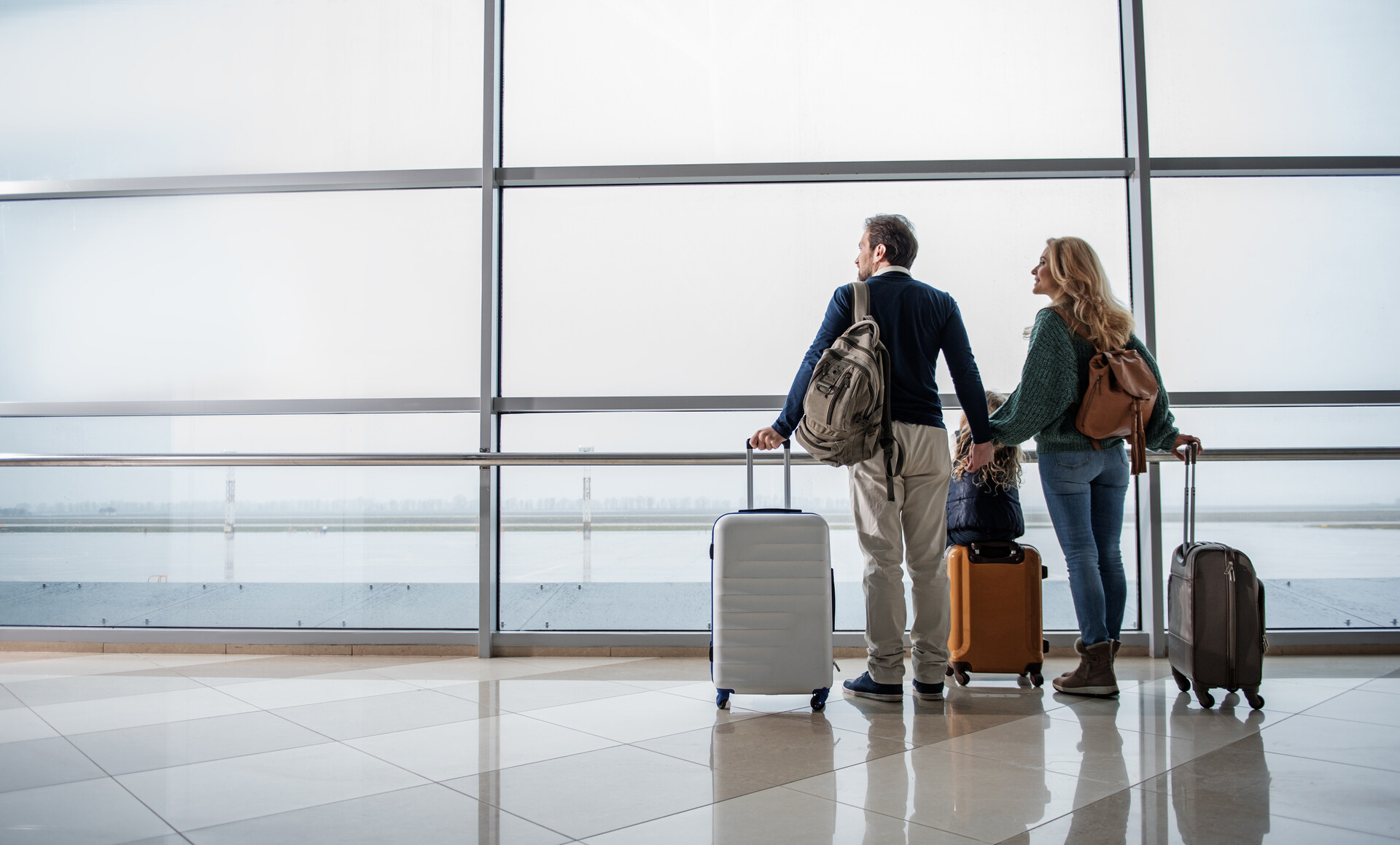 Couple standing at the airport before cross-country moving