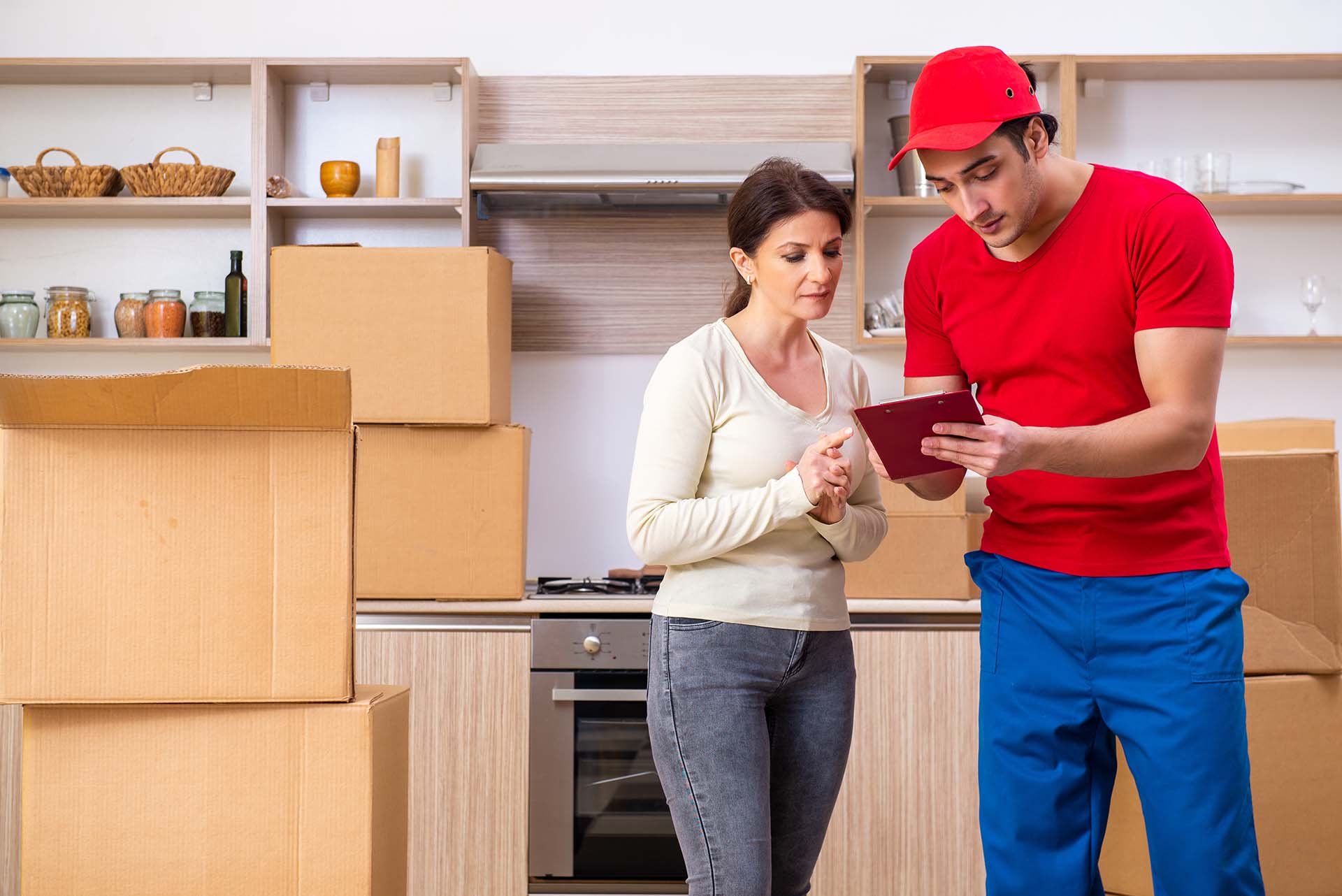 The young male contractor and female customer in moving concept