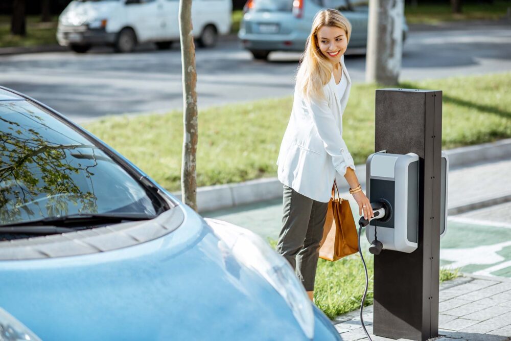 Woman charging her electric car