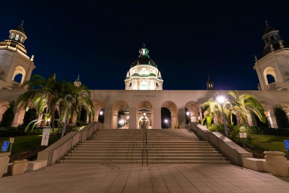 Pasadena City Hall illuminated against the night sky, featuring its iconic dome and historic architecture.