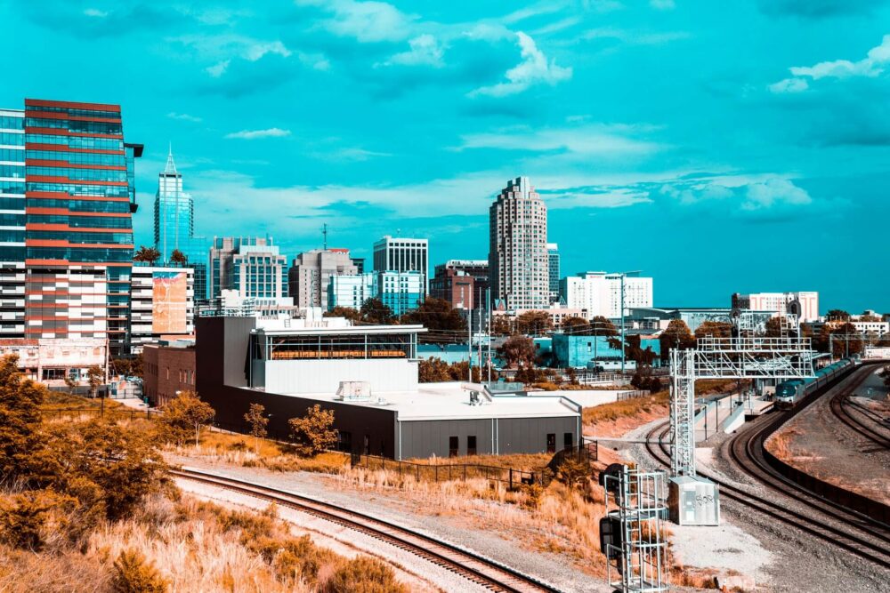 View of a modern city skyline seen from train tracks.
